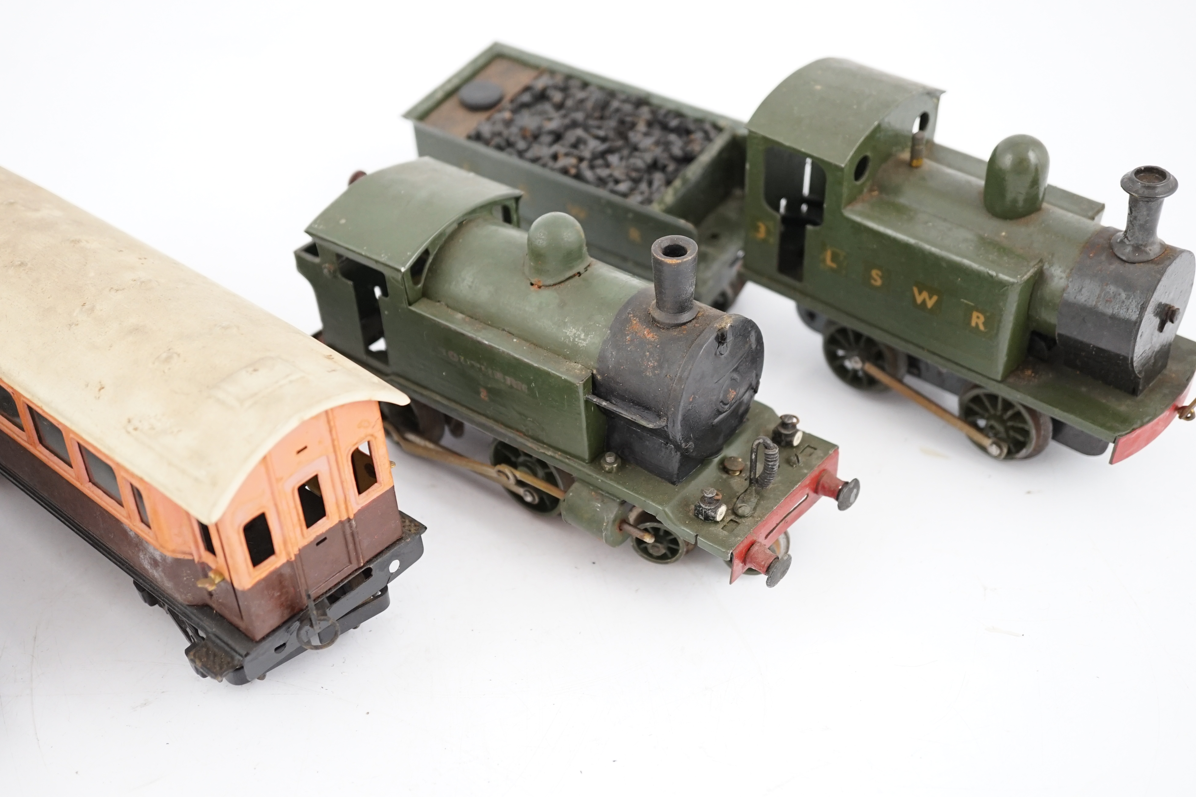 Fifteen tinplate 0 gauge railway items, including three clockwork locomotives; an LSWR 0-4-2 tender loco, an LSWR 0-4-0T and a SR 4-4-0T, all built using some commercial parts with some elements scratch built